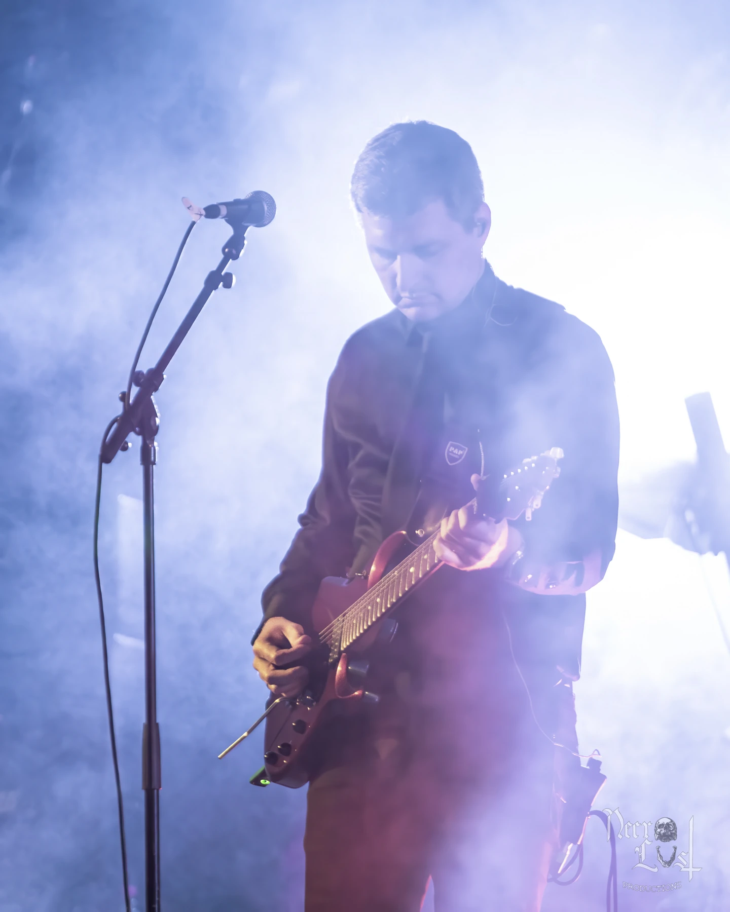Tom playing guitar on stage